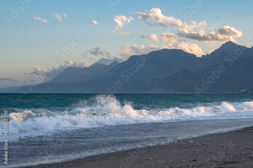 Fototapeta Naklejka Na Ścianę i Meble -  Waves on Konyaalti beach in Antalya with mountains covered in snow in the background