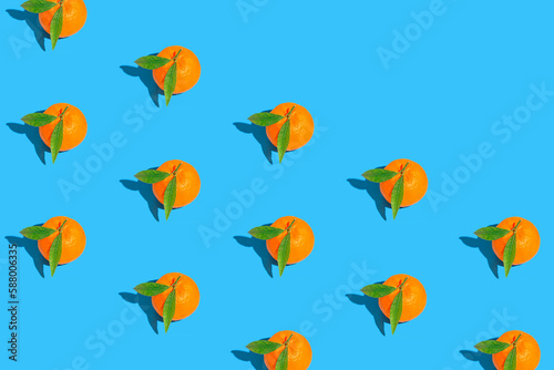 Fototapeta Naklejka Na Ścianę i Meble -  Creative pattern made of fresh orange tangerins on bright blue background. Healthy food concept. Summer refreshment theme.