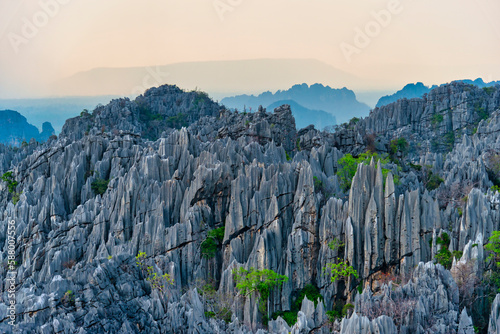 Sharp limestone mountains behind the clouds in Phu Hin Rong Kla National Park photo
