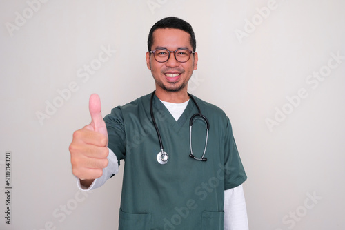 Asian hospital nurse smiling and give thumb up photo