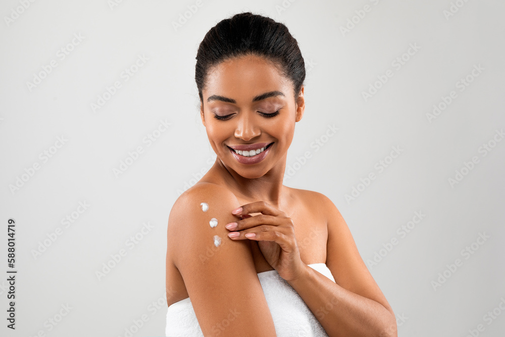 Sexy young black woman using body lotion after shower Stock Photo Adobe Stock