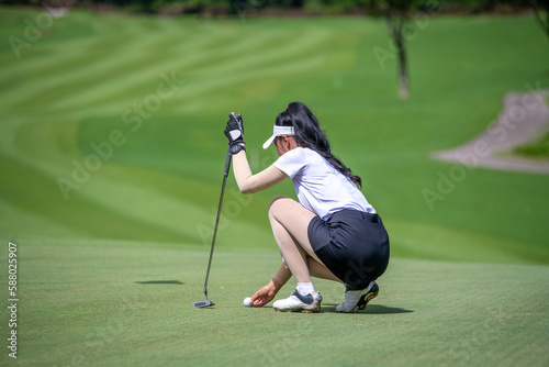 Professional golfer checking fairway and teeing golf in golf tournament competition at golf course for winner. photo