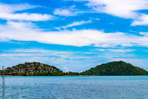 Travel Thailand by ferry boat yacht waves through tropical landscape.