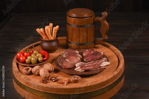 Dried Processed Beef Jerky with spices on a wood cut against dark background. Natural snack for beer. Organic food