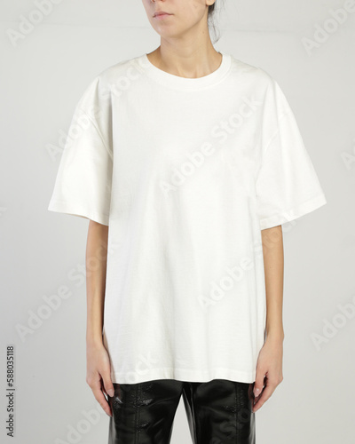 A woman wears a white over size t shirt