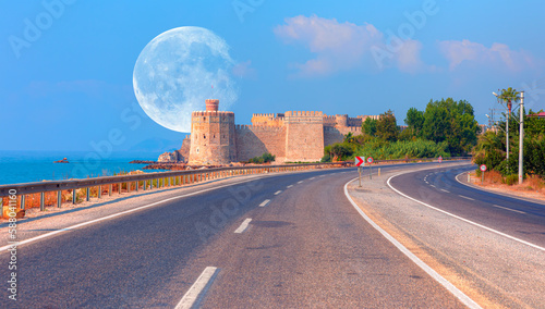 Amazing Mamure Castle with Full Moon, asphalt road in the foreground - Anamur Turkey "Elements of this image furnished by NASA"