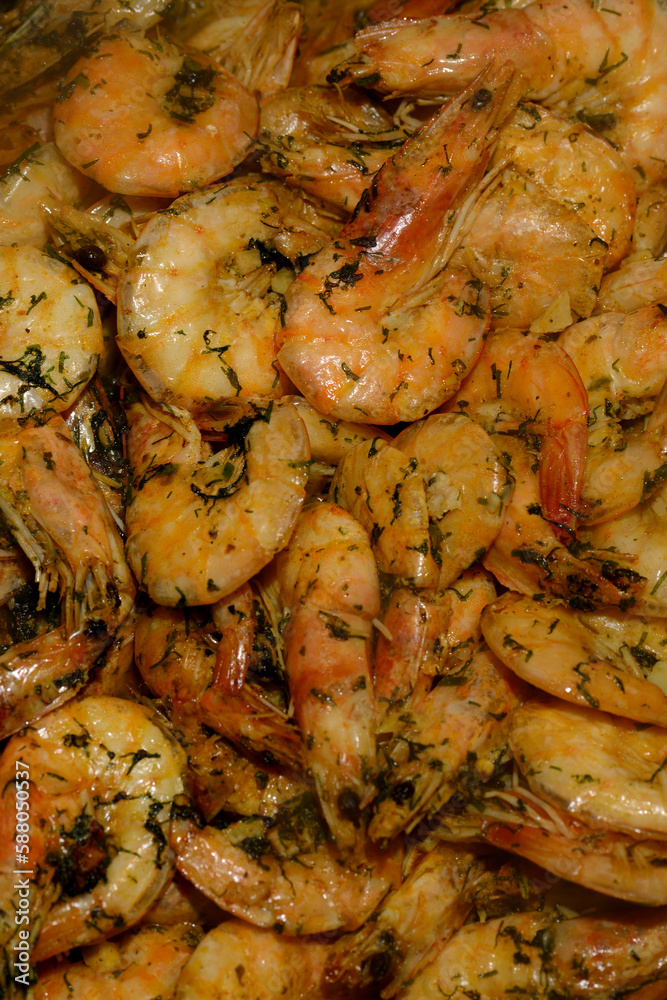 Delicious red fried unpeeled tiger prawns with the addition of oil, herbs, garlic and spices. Fried shrimp with dill and garlic. View from above. Close-up. Fragrant hot shrimp cooked in a frying pan Delicious red fried unpeeled tiger prawns with the addition of oil, herbs, garlic and spices. Fried shrimp with dill and garlic. View from above. Close-up. Fragrant hot shrimp cooked in a frying pan