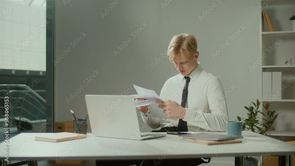 Engineer Bursting with Joy Reviewing Documents. Successful Man Making Profitable Deal and Celebrating the End of the Project.Young Smiling Architect Scatterring Papers around Him Waving Fists Happily Engineer Bursting with Joy Reviewing Documents. Successful Man Making Profitable Deal and Celebrating the End of the Project.Young Smiling Architect Scatterring Papers around Him Waving Fists Happily