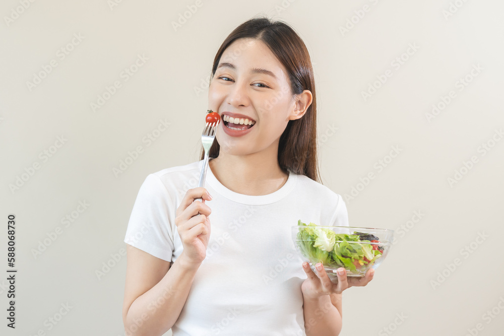 Diet, Dieting asian young woman or girl use fork at tomato on mix vegetables, green salad bowl, eat food is low fat good health. Nutritionist female, Weight loss for healthy person. Diet, Dieting asian young woman or girl use fork at tomato on mix vegetables, green salad bowl, eat food is low fat good health. Nutritionist female, Weight loss for healthy person.