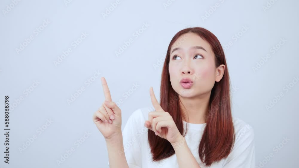 Excited long-haired woman with and pointing at a billboard in the background above. Excited long-haired woman with and pointing at a billboard in the background above.
