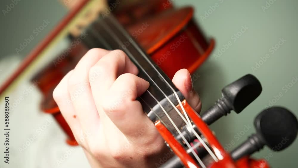 Learning to play the violin. Closeup fingers on the neck of violin Learning to play the violin. Closeup fingers on the neck of violin