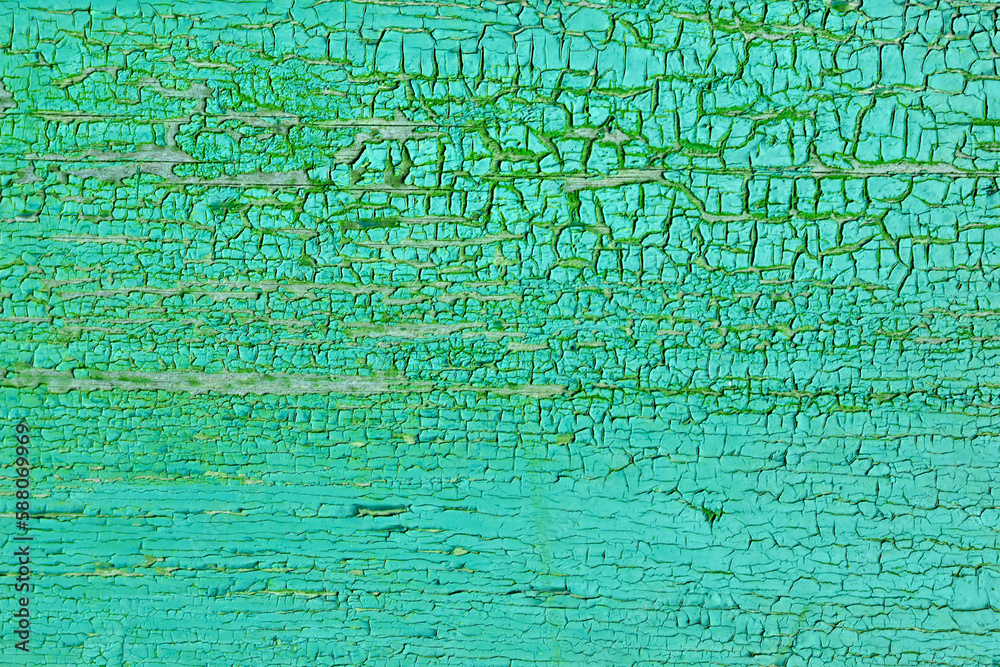 Abstract background of cracked weathered old wood with layers of paint