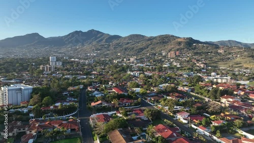 Beautiful neighborhoods of San Jose, Costa RIca suburbs drone video flying over city houses with mountains in background photo
