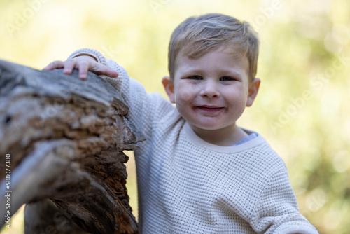 Smiling toddler posing outdoors
