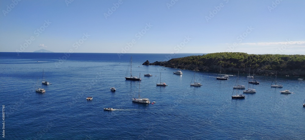 elba coast line boats in bay summer blue sky