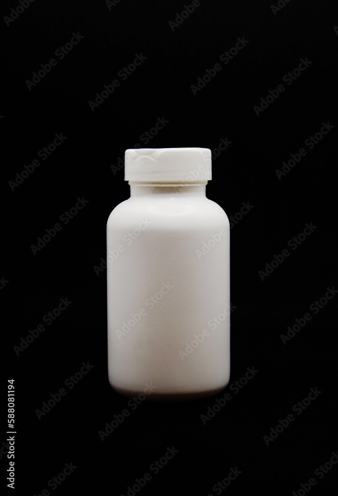 open white medicine bottle on the black background open white medicine bottle on the black background
