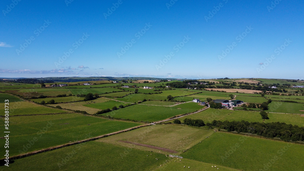 Clear sky over the fields of southern Ireland. Picturesque summer landscape, sunny day. Green grass field under blue sky