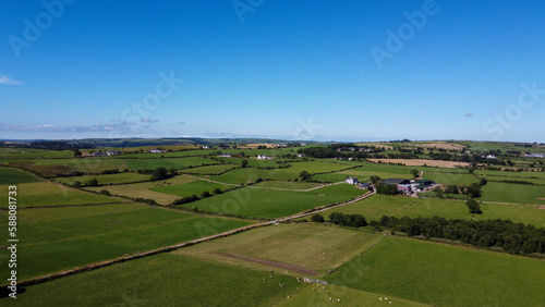 Clear sky over the fields of southern Ireland. Picturesque summer landscape, sunny day. Green grass field under blue sky