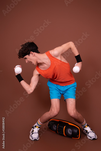 Retro style. A young attractive guy is doing aerobics.