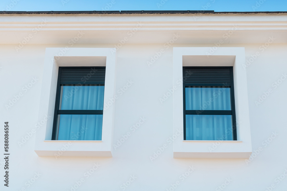 Window with shutters.  Detail of a  home exterior facade at a residential neighborhood .