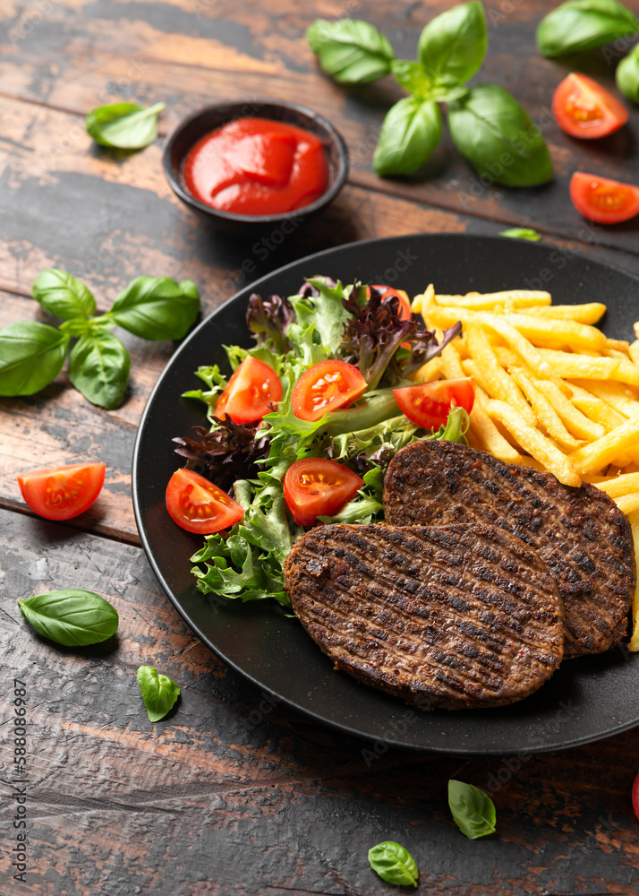 Peppered Vegetarian steaks served with french fries and salad Peppered Vegetarian steaks served with french fries and salad