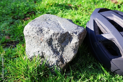 Cobblestone and bicycle helmet in close up. Concept Belgian cycling classic Paris-Roubaix. photo