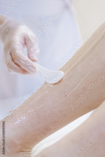 shaving leg with laser. beauty treatment