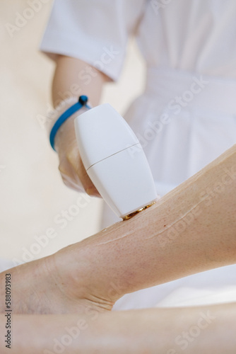 shaving leg with laser. beauty treatment