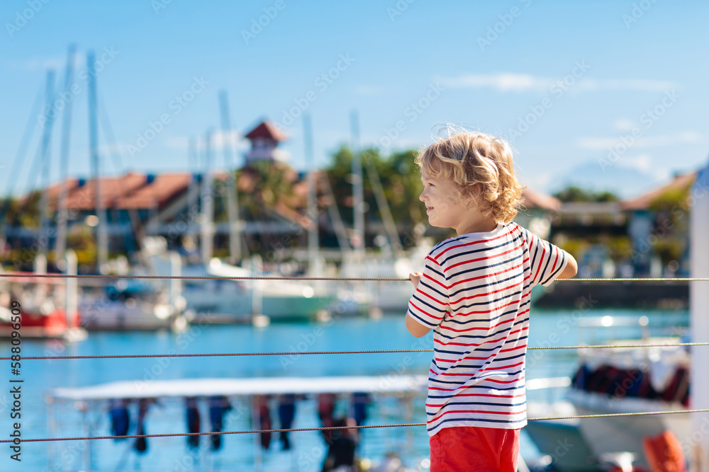 Child watching yacht and boat in harbor. Yachting. Child watching yacht and boat in harbor. Yachting.