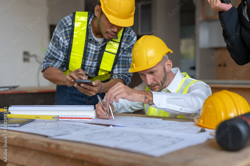 Architect and engineer work together with a sketch of the building and discussing it at the construction site. Architect and engineer work together with a sketch of the building and discussing it at the construction site.