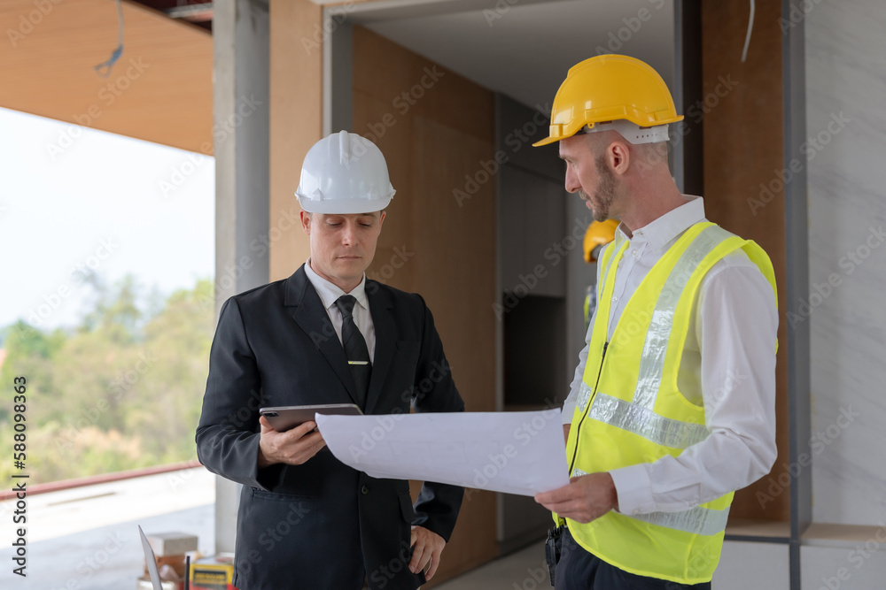 Architect and engineer work together with a sketch of the building and discussing it at the construction site. Architect and engineer work together with a sketch of the building and discussing it at the construction site.