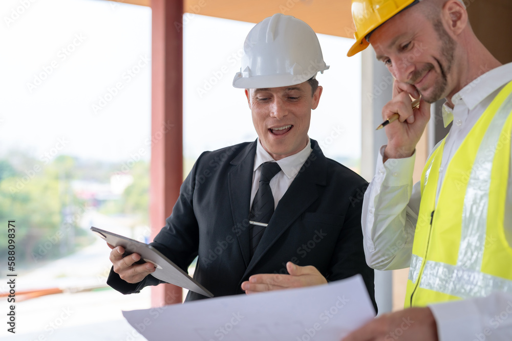 Architect and engineer work together with a sketch of the building and discussing it at the construction site. Architect and engineer work together with a sketch of the building and discussing it at the construction site.