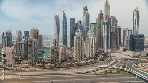 Skyscrapers of Dubai Marina near intersection on Sheikh Zayed Road with highest residential buildings all day timelapse