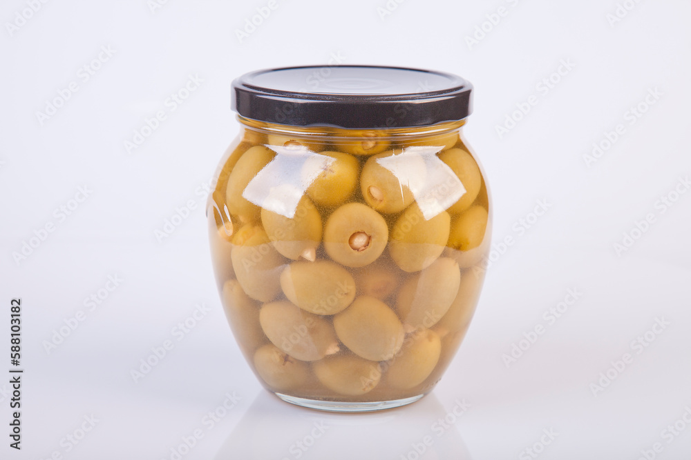 Jar of almond stuffed green olives on a white background. Jar of garlic stuffed olives isolated on white. Jar of almond stuffed green olives on a white background. Jar of garlic stuffed olives isolated on white.