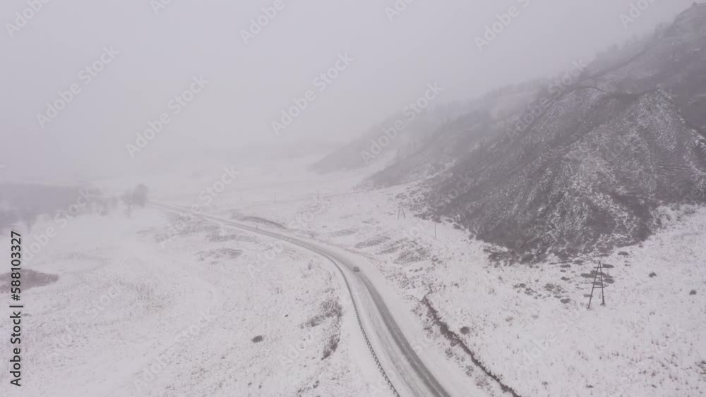 Aerial view of winter road during the foggy weather. Extreme weather conditions Aerial view of winter road during the foggy weather. Extreme weather conditions