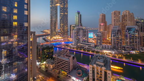 Dubai Marina skyscrapers and JBR district with luxury buildings and resorts aerial day to night timelapse