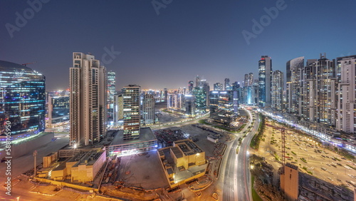 Business Bay with modern towers residential development aerial panoramic day to night timelapse, Dubai