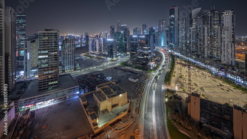 Panorama showing Bay Avenue with modern towers residential development in Business Bay aerial night timelapse, Dubai © neiezhmakov