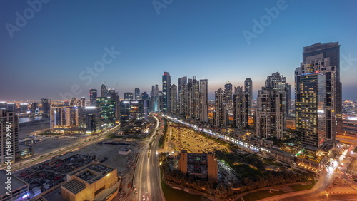 Panorama of Bay Avenue with modern towers residential development in Business Bay aerial day to night timelapse  Dubai