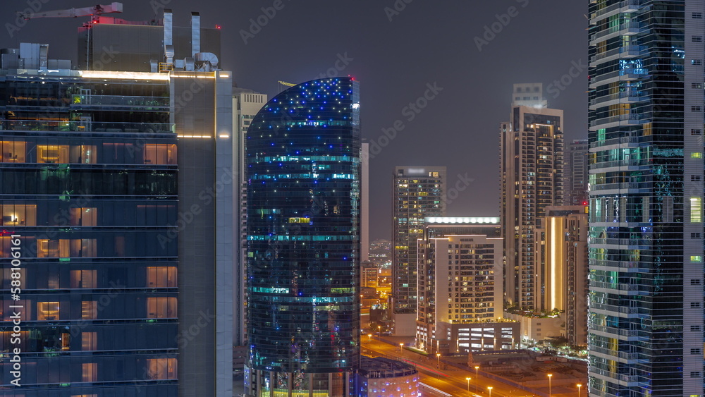 Cityscape of skyscrapers in Dubai Business Bay aerial night timelapse