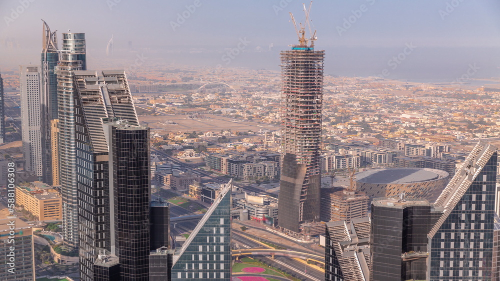 Fototapeta premium Downtown skyline with modern architecture form above timelapse. Aerial view of Dubai business bay towers.