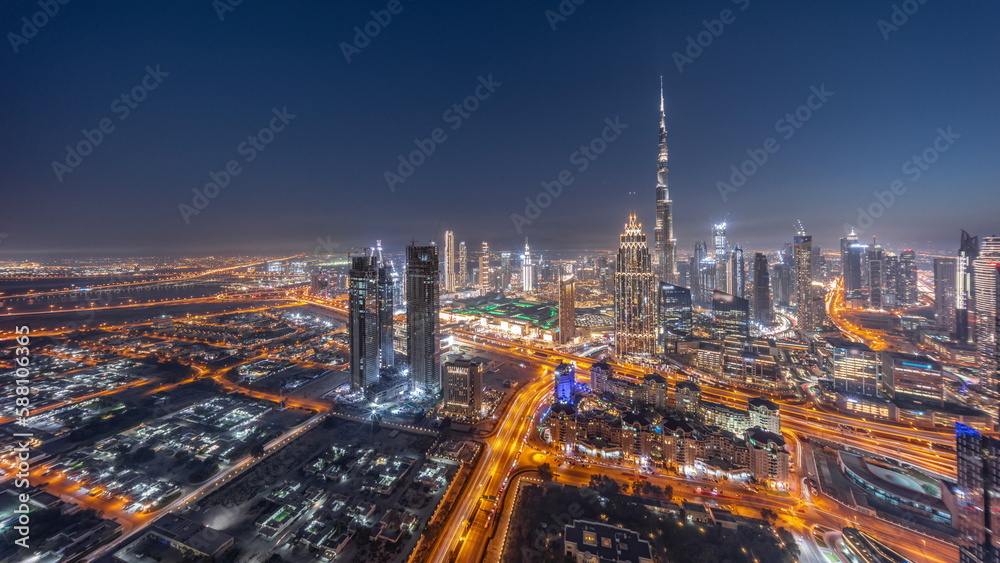 Obraz premium Aerial view of tallest towers in Dubai Downtown skyline and highway day to night timelapse.