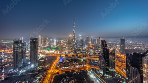 Aerial panorama view of tallest towers in Dubai Downtown skyline and highway day to night timelapse.