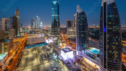 Aerial view of Dubai International Financial District with many skyscrapers day to night timelapse. © neiezhmakov