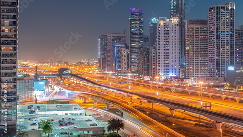 Dubai Marina skyscrapers and Sheikh Zayed road with metro railway aerial day to night timelapse, United Arab Emirates © neiezhmakov