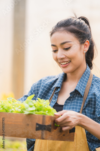 Young asian woman farmer ho...