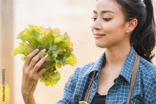 Young asian woman farmer ho...