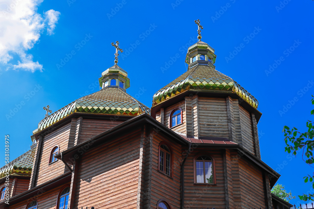 Domes with gilding on one of the ancient wooden churches in one of the small towns of Ukraine Domes with gilding on one of the ancient wooden churches in one of the small towns of Ukraine