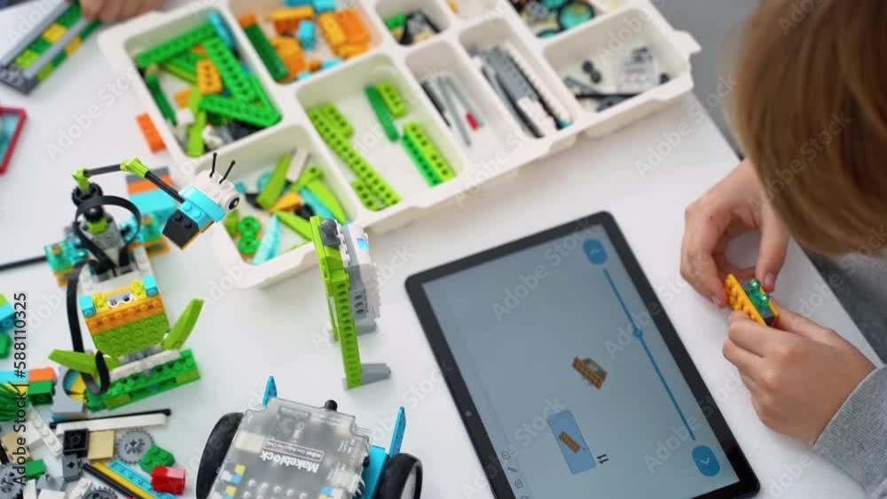 Robotics programming class. Children construct and code Robot. STEM ...