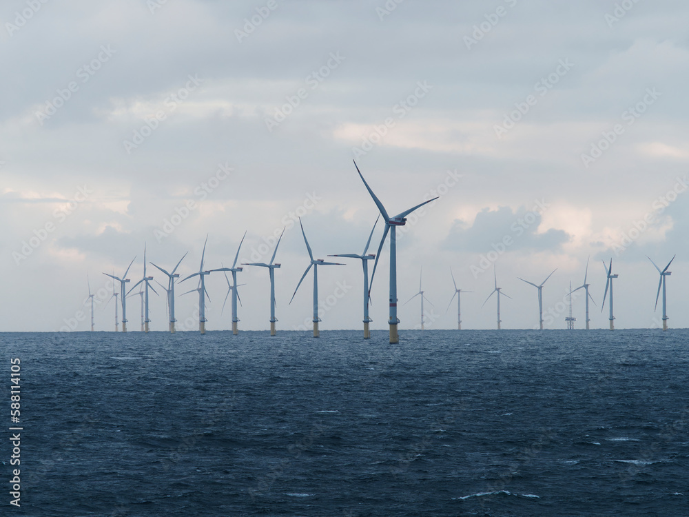 Offshore and Onshore Windmill farm Westermeerwind, Windmill park in the Netherlands with huge large wind turbines, group of windmills for renewable electric energy